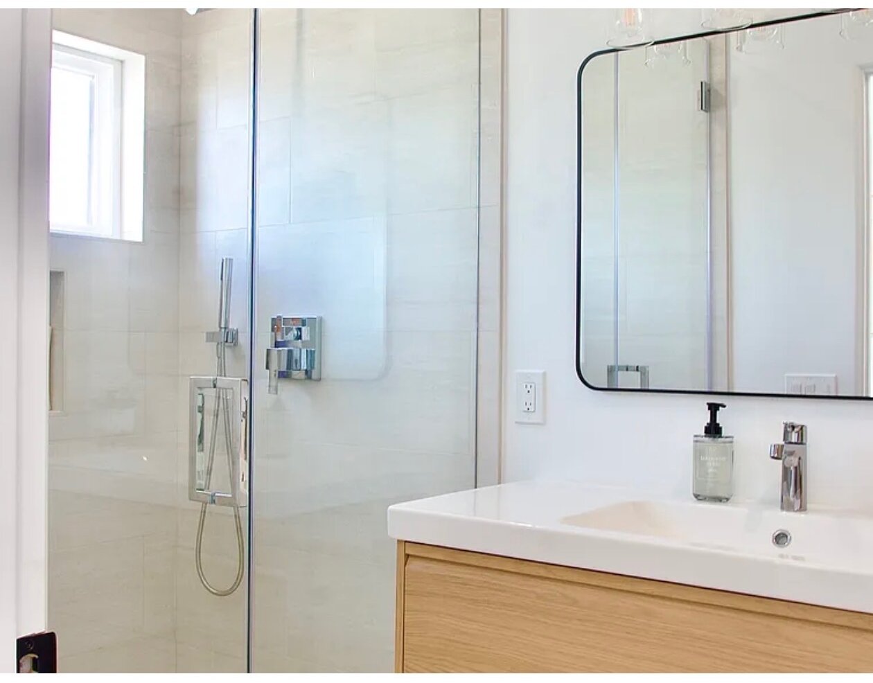 Guest Suite No. 2 bathroom, with a glass walk-in shower beside an oak vanity