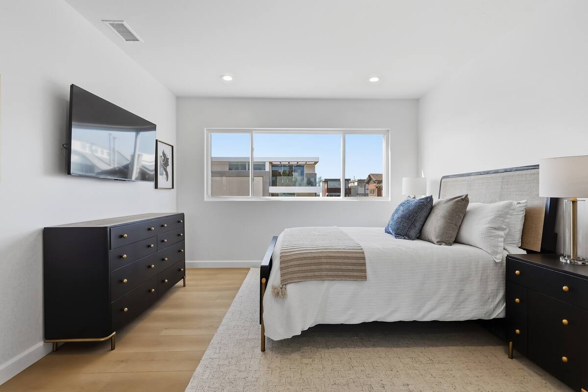 Guest Suite No. 3, with a bright window and layered linens