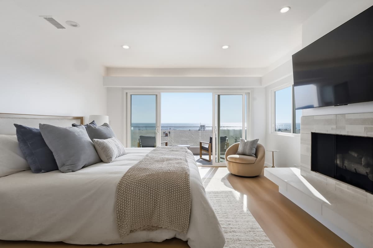 Spacious primary suite with sitting area and ocean view