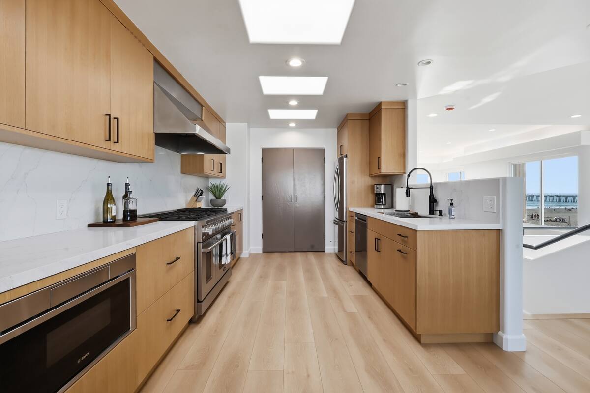 Galley kitchen with professional range and wood cabinetry