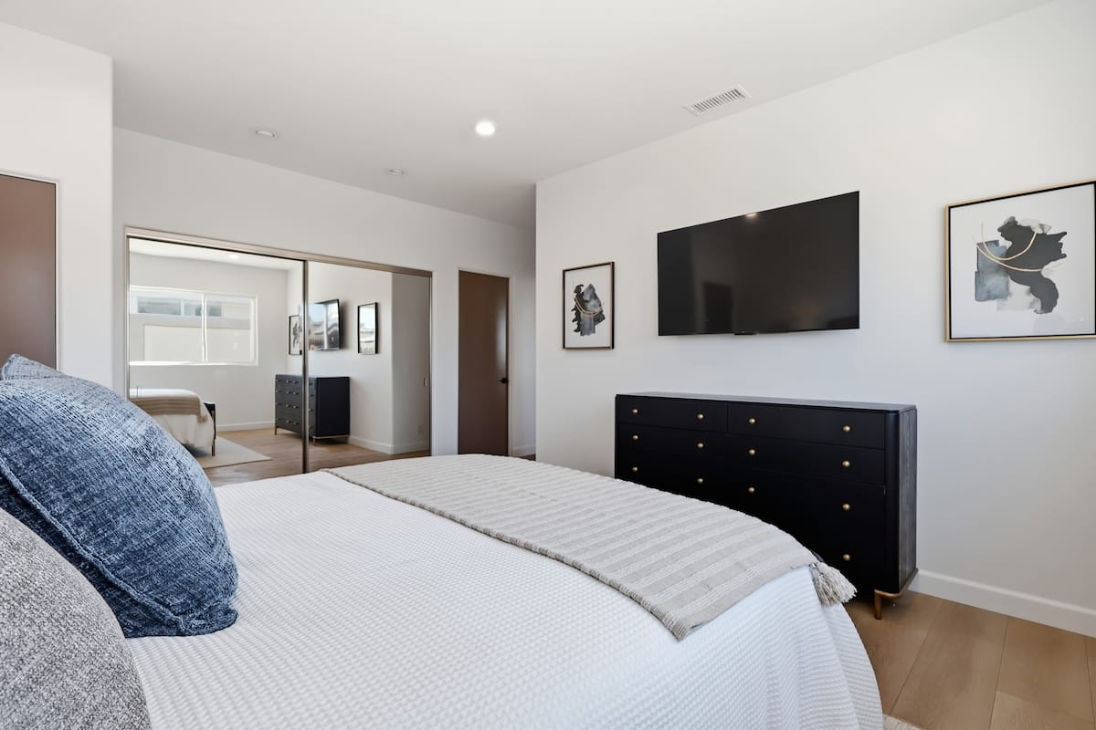 Guest suite with upholstered bed and layered linens